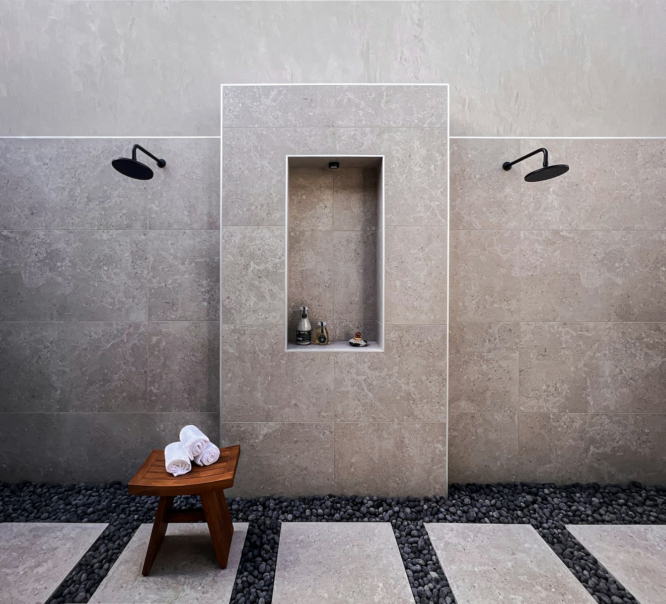 a bathroom with a bench and a shower